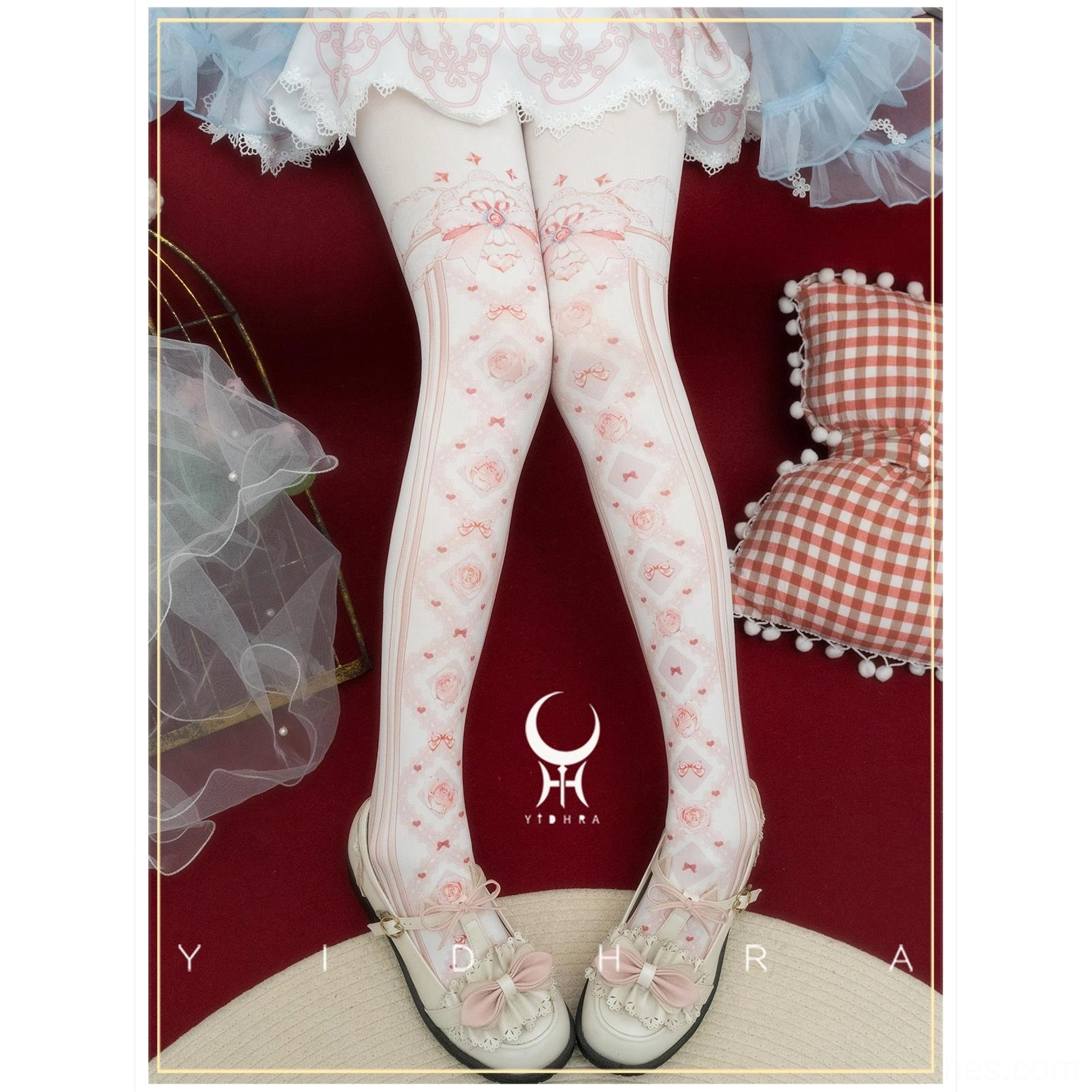 Red floral print lolita pantyhose with bow accents worn with white ruffled lolita skirt and vintage Mary Jane flats in retro studio setting