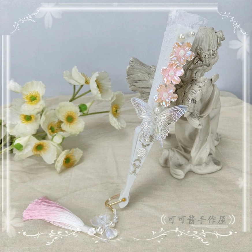 Sweet light pink lolita folding fan side display with clear silver butterfly ornament and pink-white gradient tassel bead pendant on elegant background