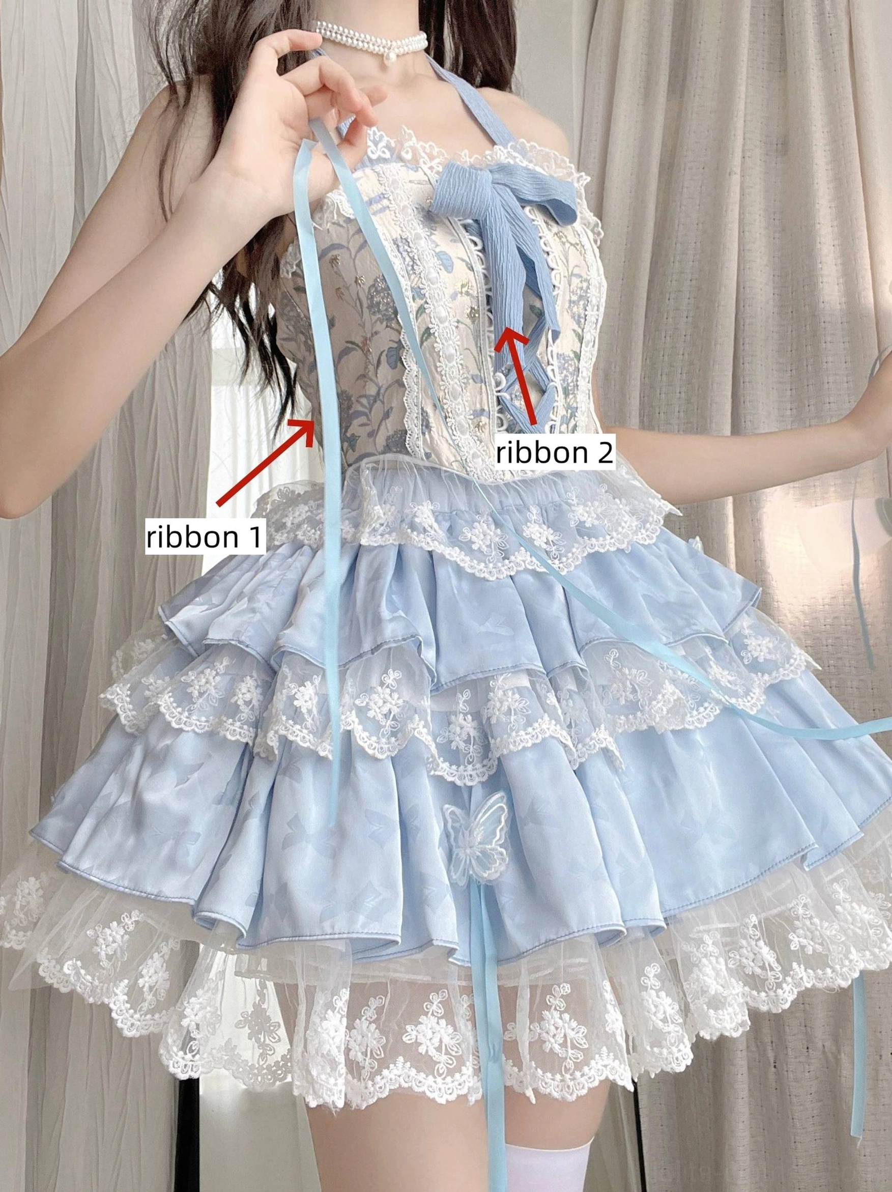 Detailed close-up of sweet lolita ballet bodice showing two interchangeable satin ribbons floral patterned fabric bodice and layered ruffled lace skirt construction without model focus on dress details