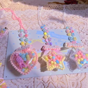 Two matching sweet lolita beaded necklaces with pastel ribbon accents and pom-pom filled pendants on light blue bear print card