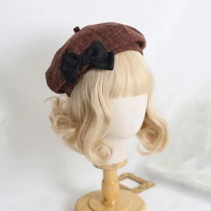 Caramel plaid sweet lolita beret with black satin bow ornament front view on blonde curly wig mannequin, octagonal woolen plaid texture, Japanese daily lolita headpiece with detachable bow