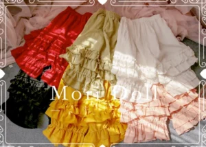 Sweet Lolita bloomers in solid colors including black white pink ginger light green and burgundy displayed in flat lay with double-layer ruffled hem and elastic waist design
