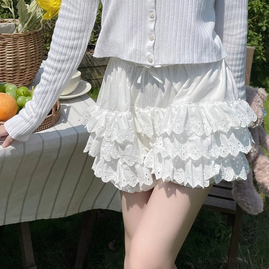 Sweet Lolita bloomers tiered lace detail showing the scalloped embroidered layers and soft pink color palette
