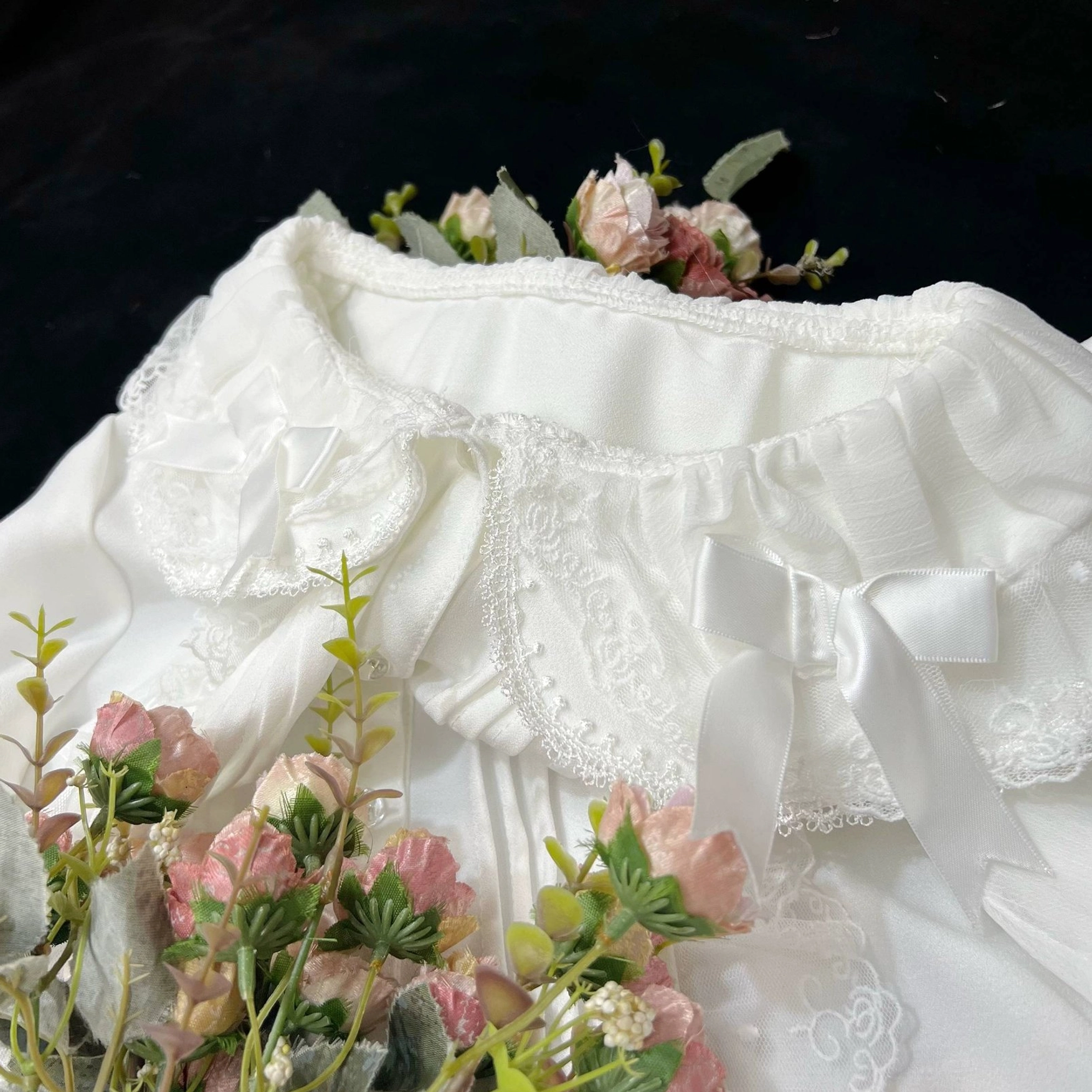 Detailed close-up of sweet Lolita blouse's front bodice lace pintucks and decorative trim work showcasing construction quality and ornamental details
