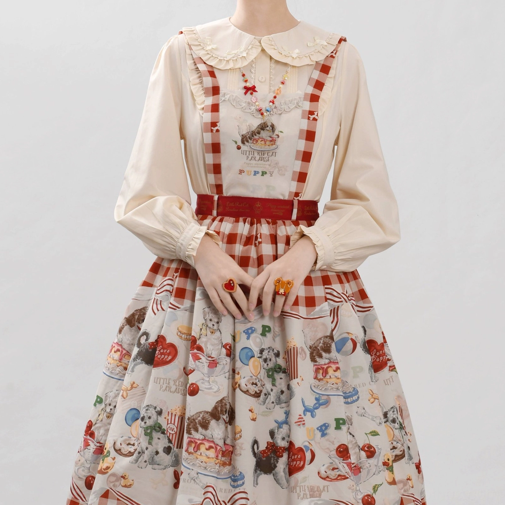 Sweet lolita blouse close-up lace trim peter pan collar delicate ruffle details bow front chest studio shot