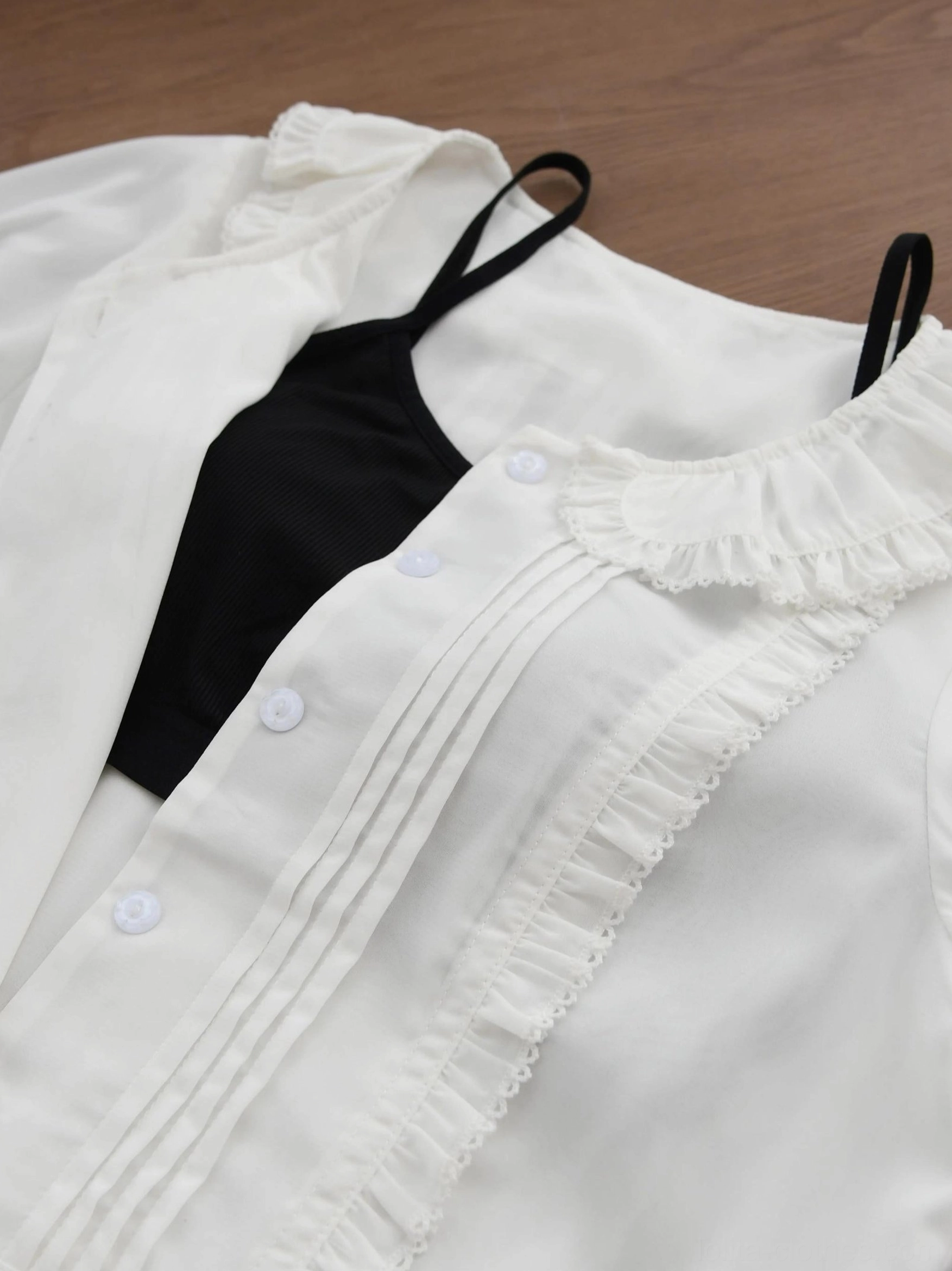 Sweet Lolita Peter Pan collar blouse sleeve and cuff close-up showing elastic cuff opening, ruffled short puff sleeve construction, and intricate stitching