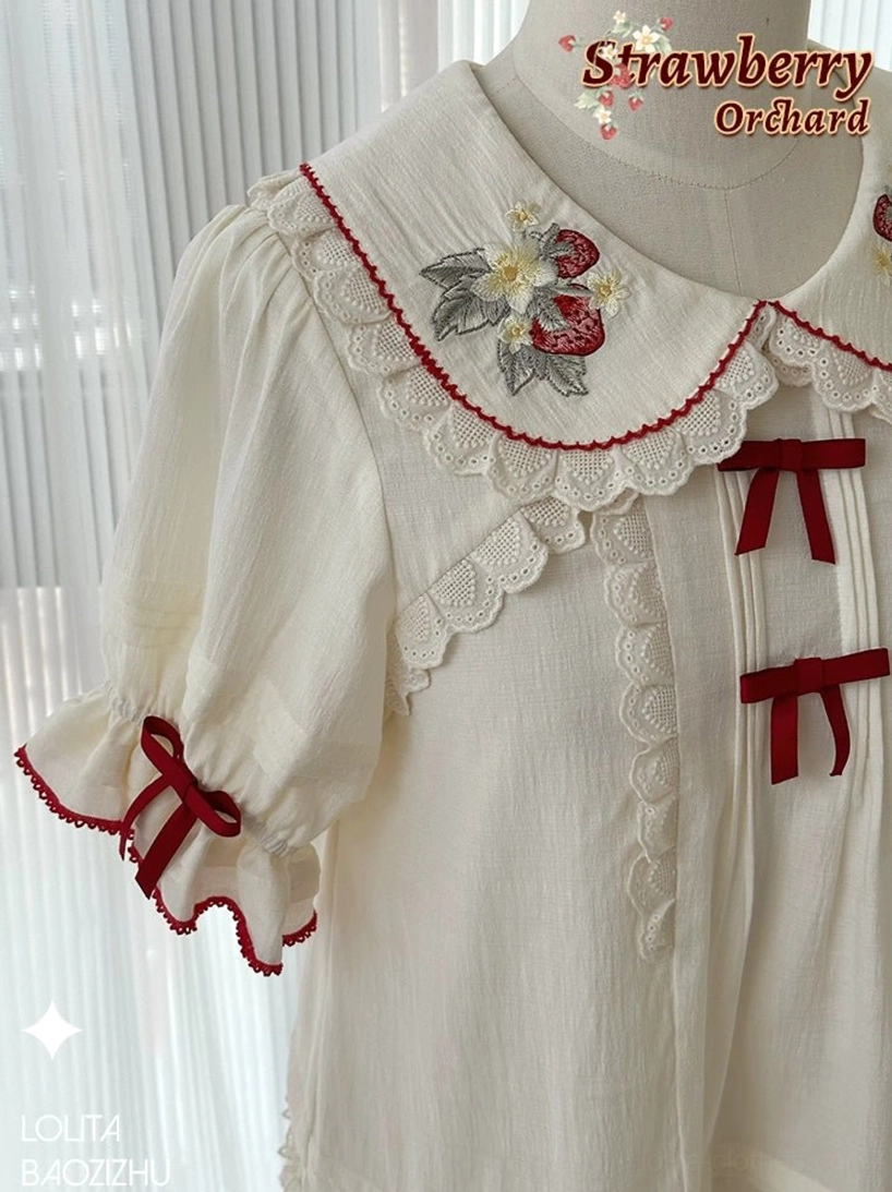 Close-up upper body view of strawberry embroidered sweet lolita blouse showing intricate Peter Pan collar embroidery detailing and scalloped lace trim on sleeves