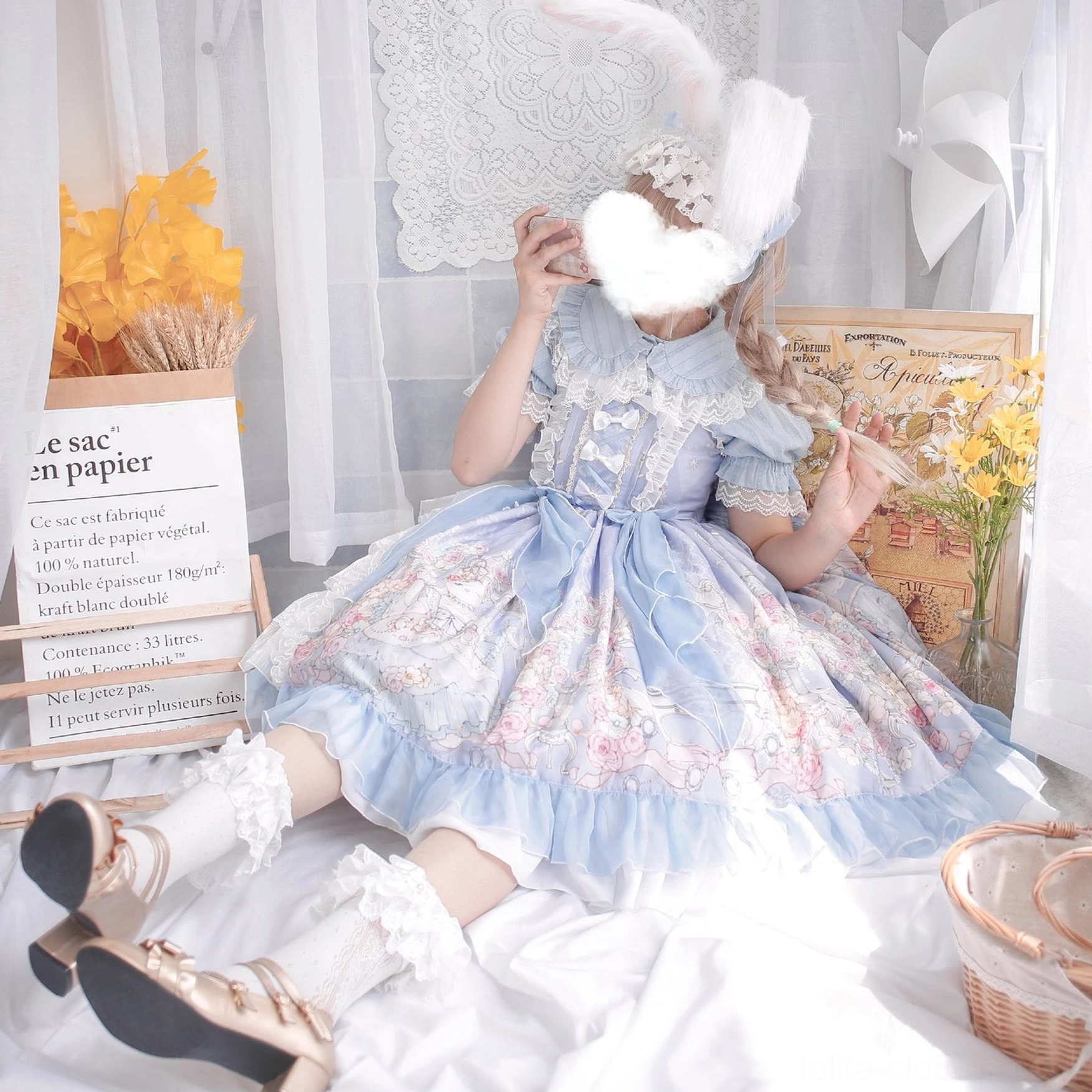 Blue sweet lolita short sleeve blouse with peter pan collar puff sleeves model sitting indoor vintage stationery decor