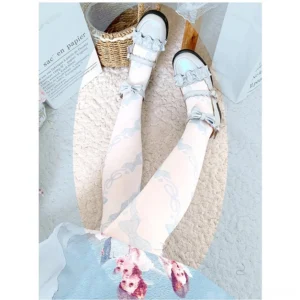 Pale blue Sweet Lolita bow print velvet knee-high stockings with light blue frilly Mary Jane shoes and blue floral Lolita skirt overhead flat lay