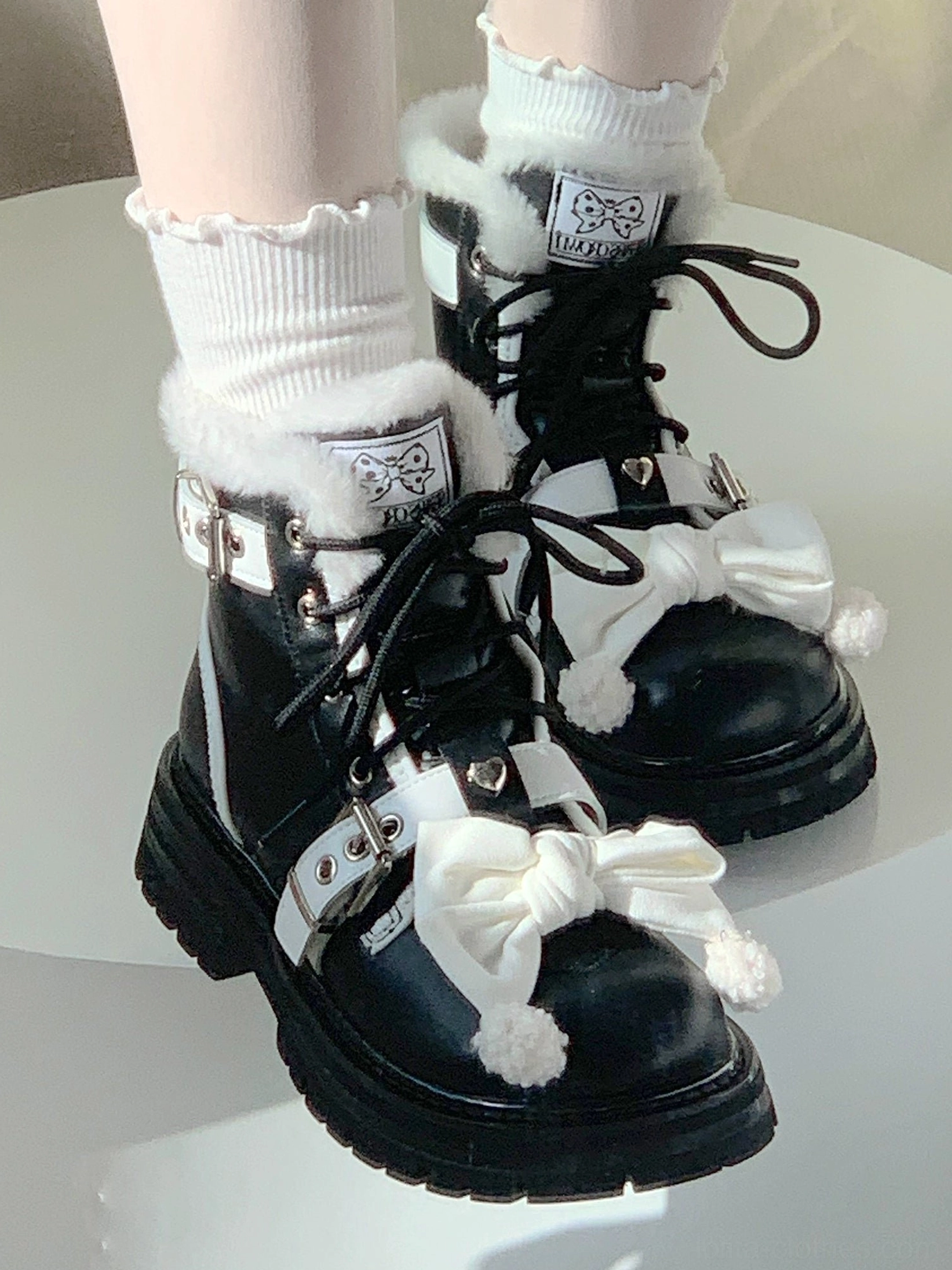 Sweet lolita martin boots white decorative bow pom-poms black smooth leather white buckle straps fuzzy fur collar top-down view