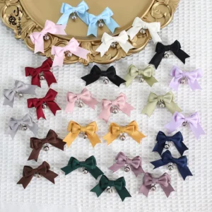 Multicolor satin bow hair clips with silver bells in sweet lolita style, displayed in flat lay arrangement showing smoke purple, dark blue, grass green, light blue, light purple, milk white and more colors on vintage checkered fabric