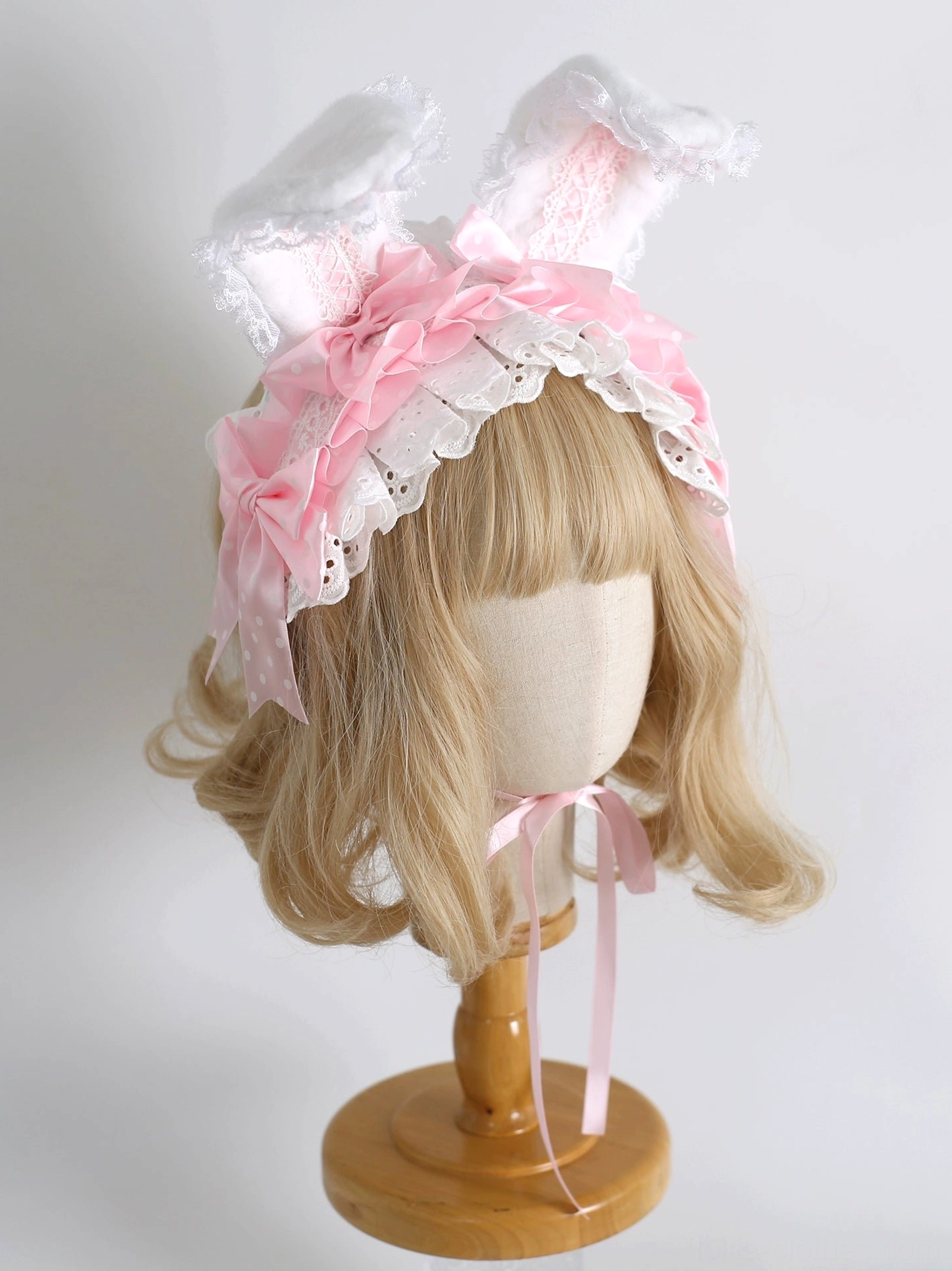 Pink sweet lolita shapeable bunny ear hairband with satin bow and white lace on wooden head mannequin