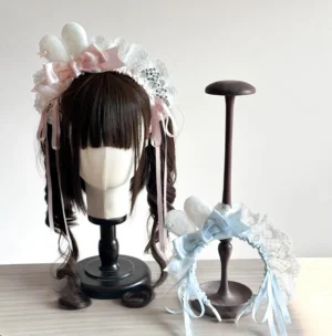 Sweet Lolita bunny ear headband with polka dot bows in pink and blue displayed on mannequin with curly wig, showcasing fluffy bunny ears and hanging ribbon tassels