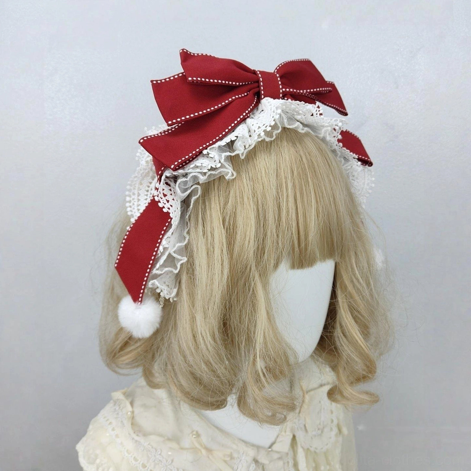Three-Quarter Front View of Burgundy Sweet Lolita Headdress with Decorative Stitching, White Lace, and Side Pompoms