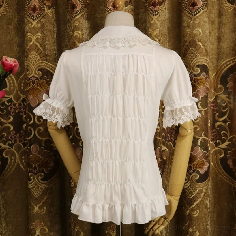 Milk white short-sleeve sweet lolita blouse back view showing shirred ruched back design, Peter Pan collar with lace trim, ruffled hem details