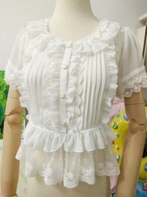 Front-facing sweet lolita chiffon blouse featuring ruffled crew neckline with lace trim, vertical pin-tucked bodice for defined silhouette, puffed short sleeves with lace-trimmed cuffs, pearl-effect front button placket, and signature dual-layer ruffled hem with dotted tulle overlay and scalloped lace trim detail