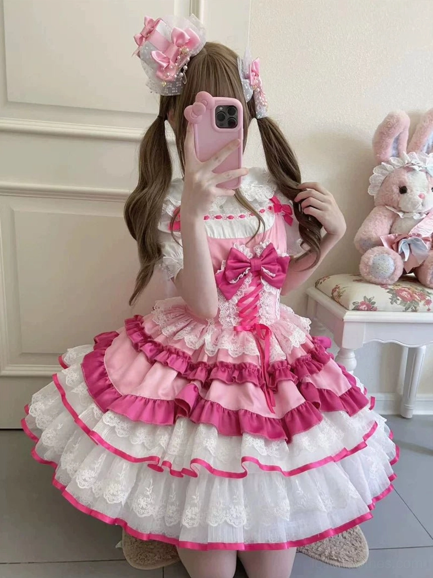 Pink sweet lolita dress model wearing twin tails hairstyle room mirror selfie tiered ruffled lace skirt large front bow styling reference