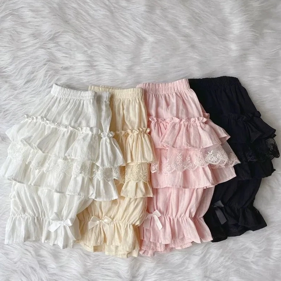 Mixed color sweet lolita cotton bloomers collection four pairs white beige pink black layered ruffles satin bows leg openings fluffy fur flat lay display