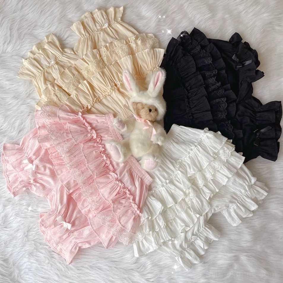 Four color options sweet lolita cotton bloomers collection white beige pink black layered ruffles delicate satin bows flat lay fluffy fur background complete set display