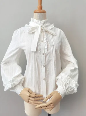 Sweet lolita long sleeve cotton blouse with removable bow front view on wooden dress form white dotted fabric bishop sleeves