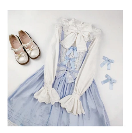 White sweet lolita cotton blouse styled with blue printed lolita jumpskirt mary jane shoes and coordinating blue bow hair accessories complete coordinate
