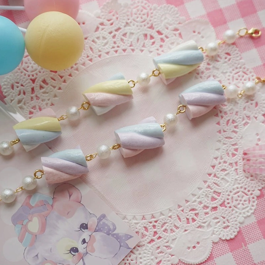 Multiple simulated cotton candy resin lolita jewelry pieces displayed together showing various angles of marshmallow charms, metal hardware details, and complete jewelry set composition