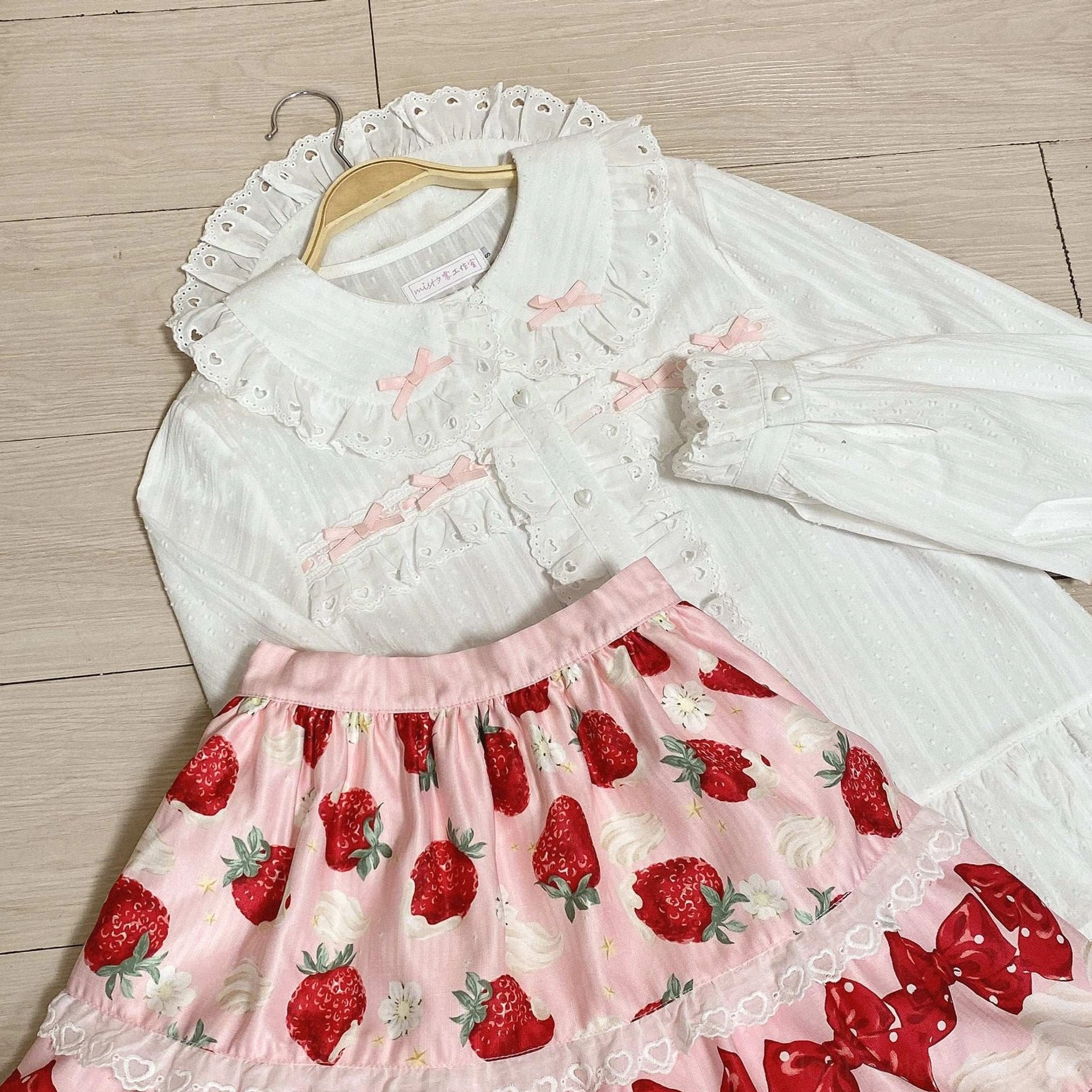 Sweet lolita cotton doll collar blouse with lace trim and ruffles romantic aesthetic styling flat lay