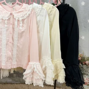 Four color options of sweet lolita long sleeve cotton shirts arranged on pink hangers, showing available colors including pink, cream white, light apricot, and black with matching ruffled collars and lace details