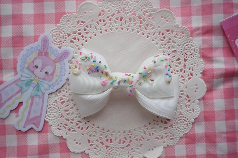 Sweet lolita cream cake bow hair clip in white color with detailed imitation cream topping and pastel candy sprinkles product view