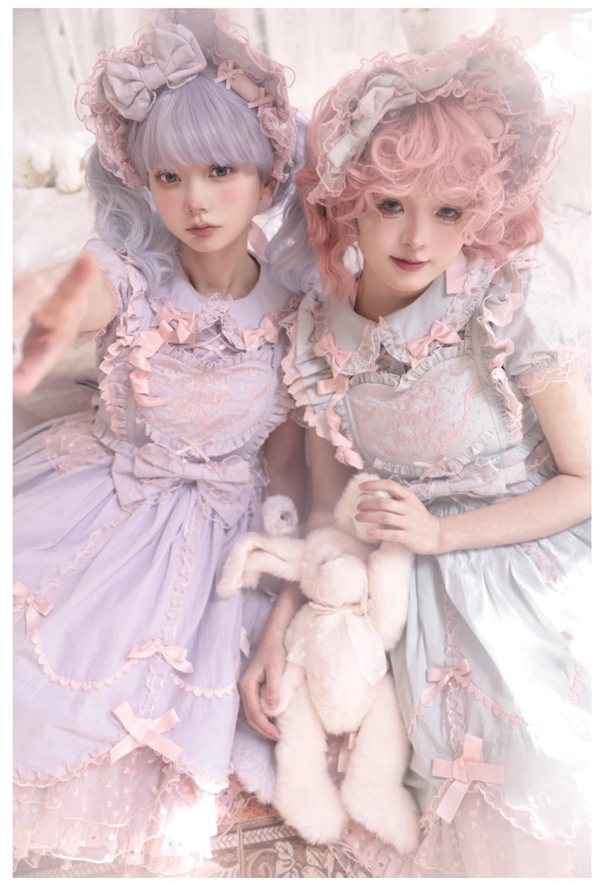Close-up upper body shot of sweet Lolita dress set featuring lace bodice embroidery heart motif and large waist bow