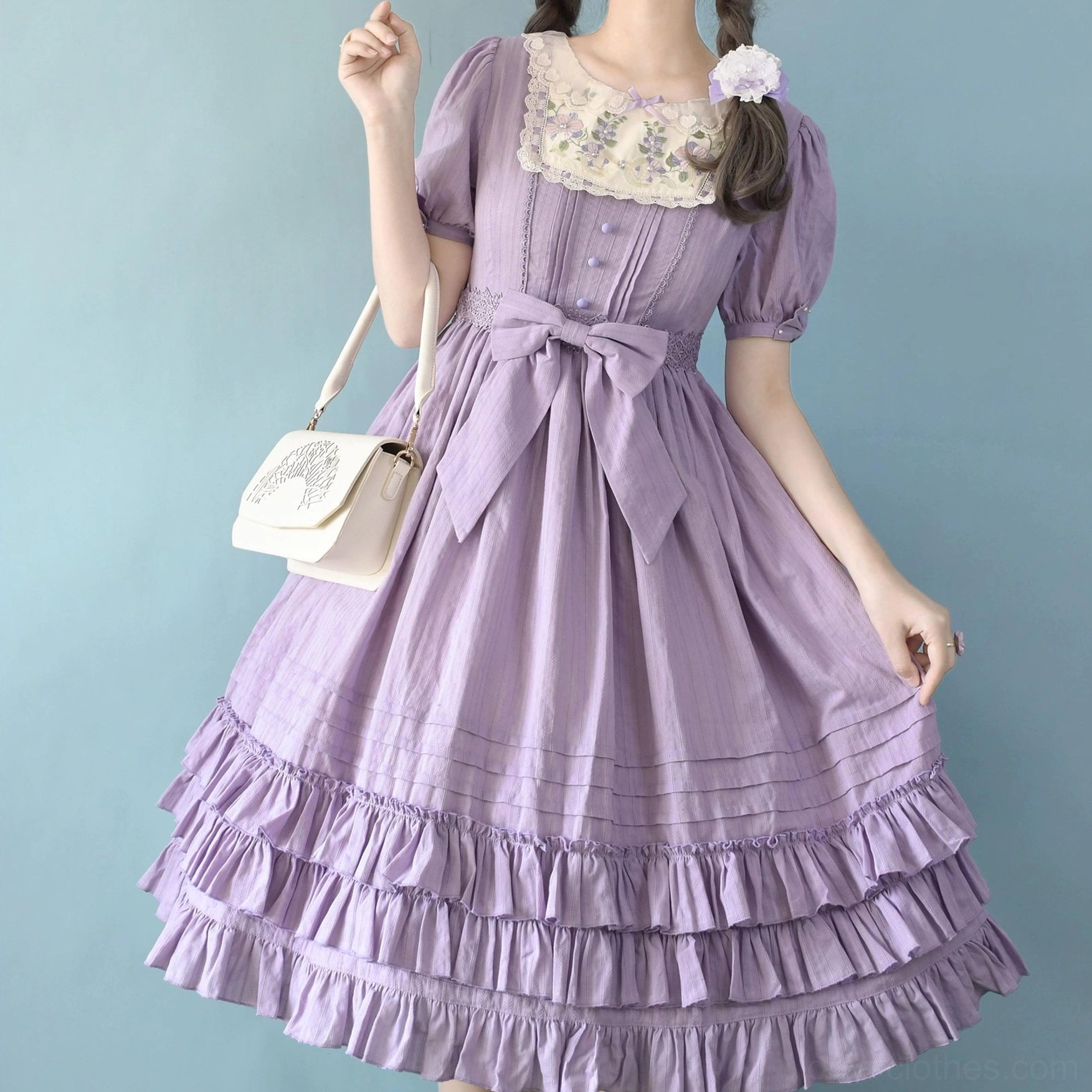 Taro purple Sweet Lolita embroidered OP dress close-up half-body shot showing short puff sleeves, front pleated details, large waist bow, multi-layer ruffled skirt, embroidered square lace neckline detail