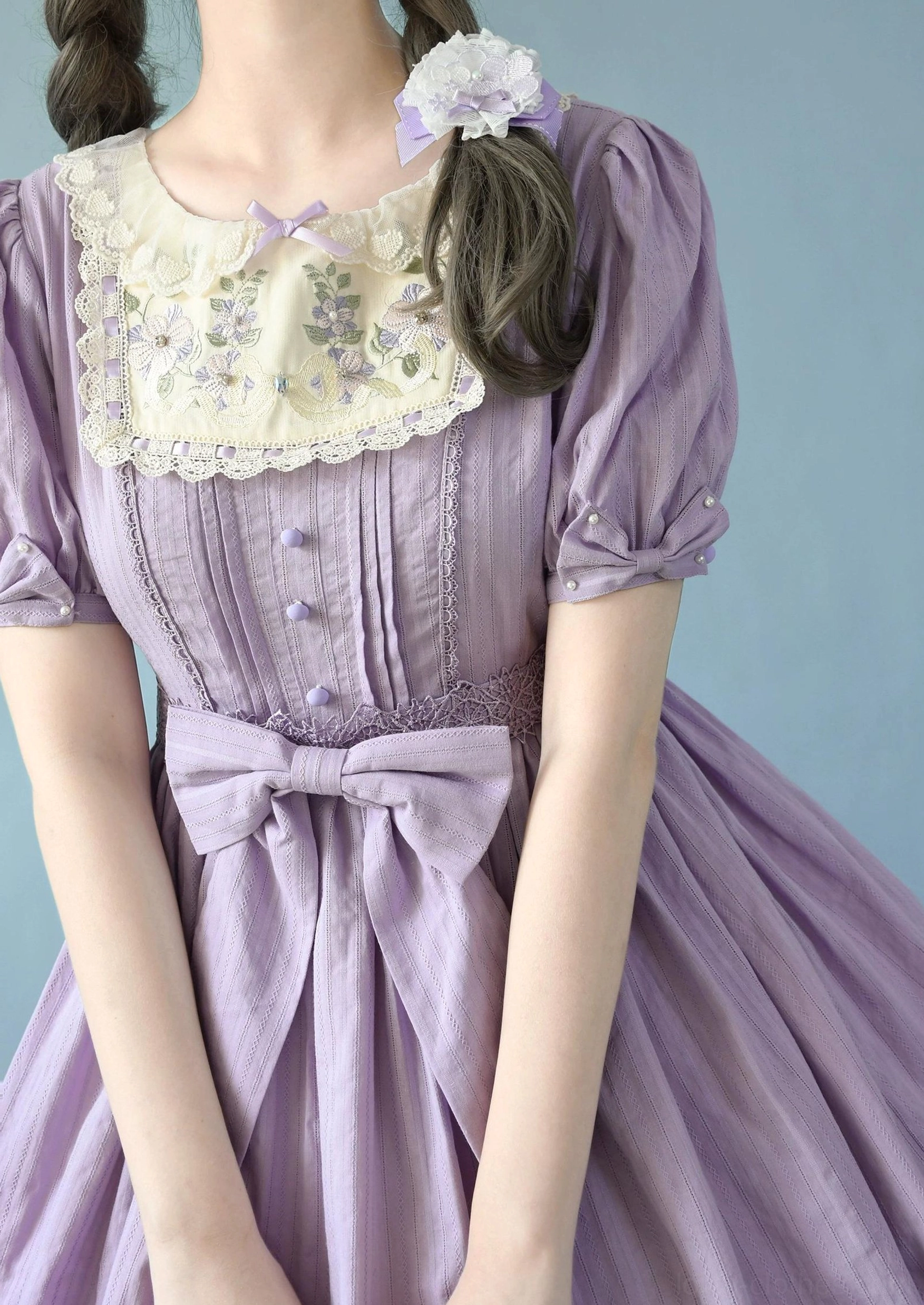 Taro purple Sweet Lolita embroidered OP dress close-up upper body detail featuring short puff sleeves, embroidered doll lace collar, front button decorations, subtle stripe jacquard fabric texture