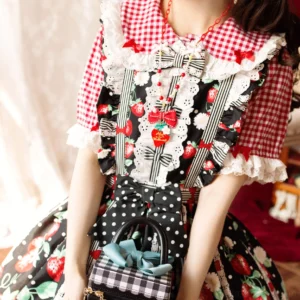 Sweet lolita fashion coordinate with strawberry print dress and matching necklace accessory worn on model