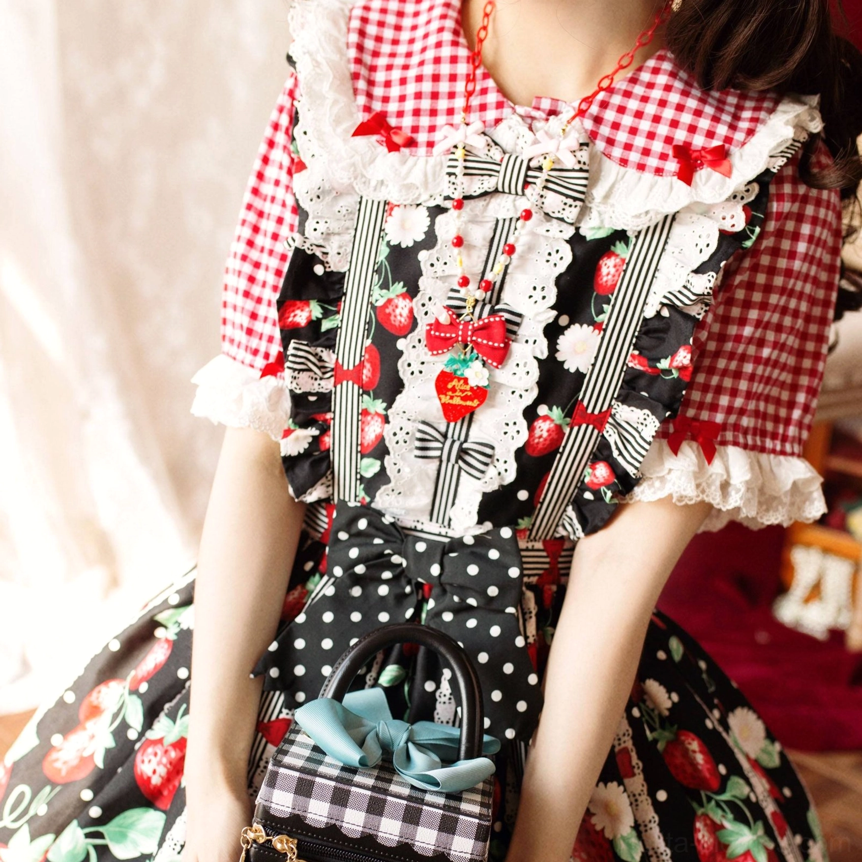 Sweet lolita fashion coordinate with strawberry print dress and matching necklace accessory worn on model