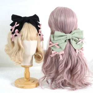Dual-style sweet lolita bow headdress set featuring oversized black and sage green bows with pink satin accents displayed on blonde mannequin wigs front and back view