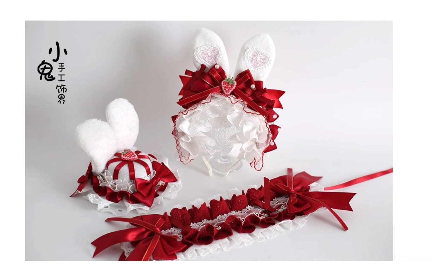 Complete sweet lolita hair accessory matching set flat lay display showing 2 bunny ear pieces, ruffled headband, mini top hat in unified red and white with strawberry theme