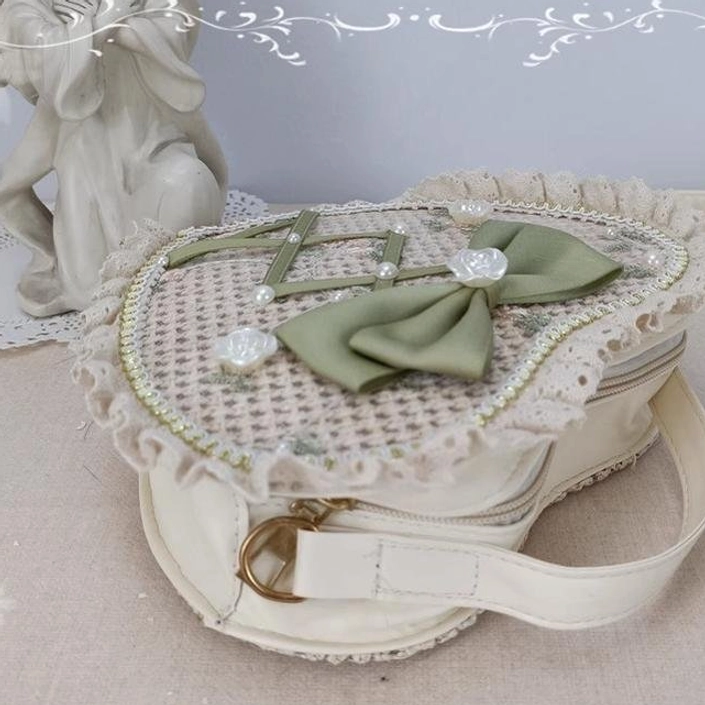 Side view of Sweet Lolita heart-shaped woven bag showing detachable PU leather shoulder strap zipper hardware lace trim and bow