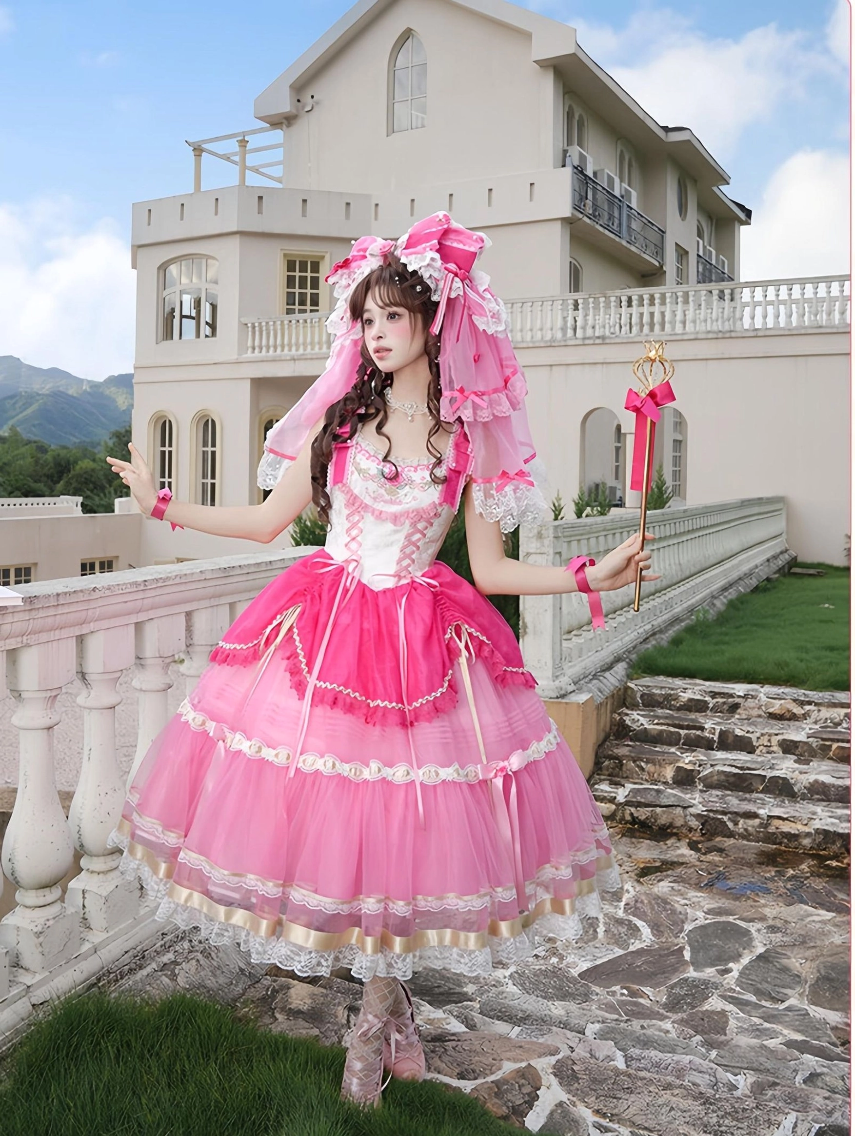 Sweet lolita princess dress one-piece hime sleeve full-body side outdoor view on villa balcony, displaying gradient pink tulle skirt with lace trimming and elegant off-white bust design detail