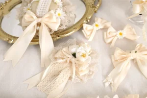 Assorted ivory sweet lolita lace hair accessories collection displayed on vintage gold tray with satin bows and fabric flowers
