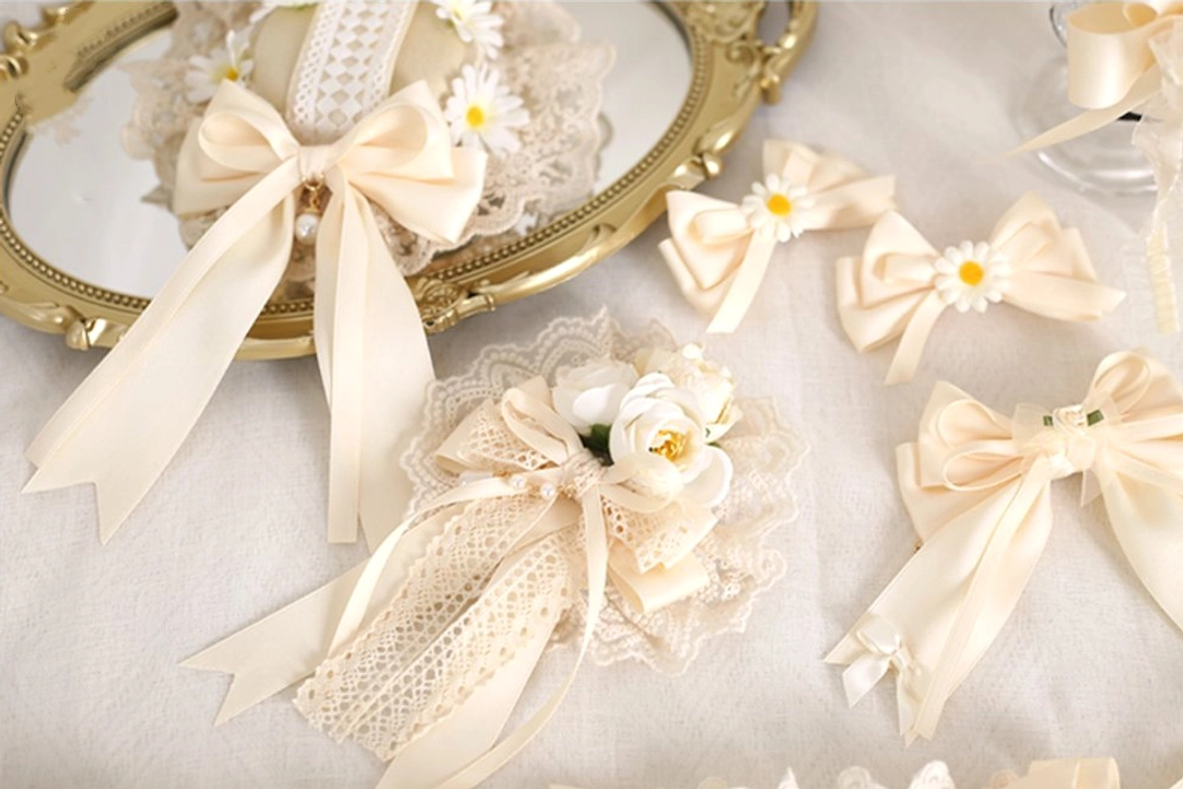 Assorted ivory sweet lolita lace hair accessories collection displayed on vintage gold tray with satin bows and fabric flowers