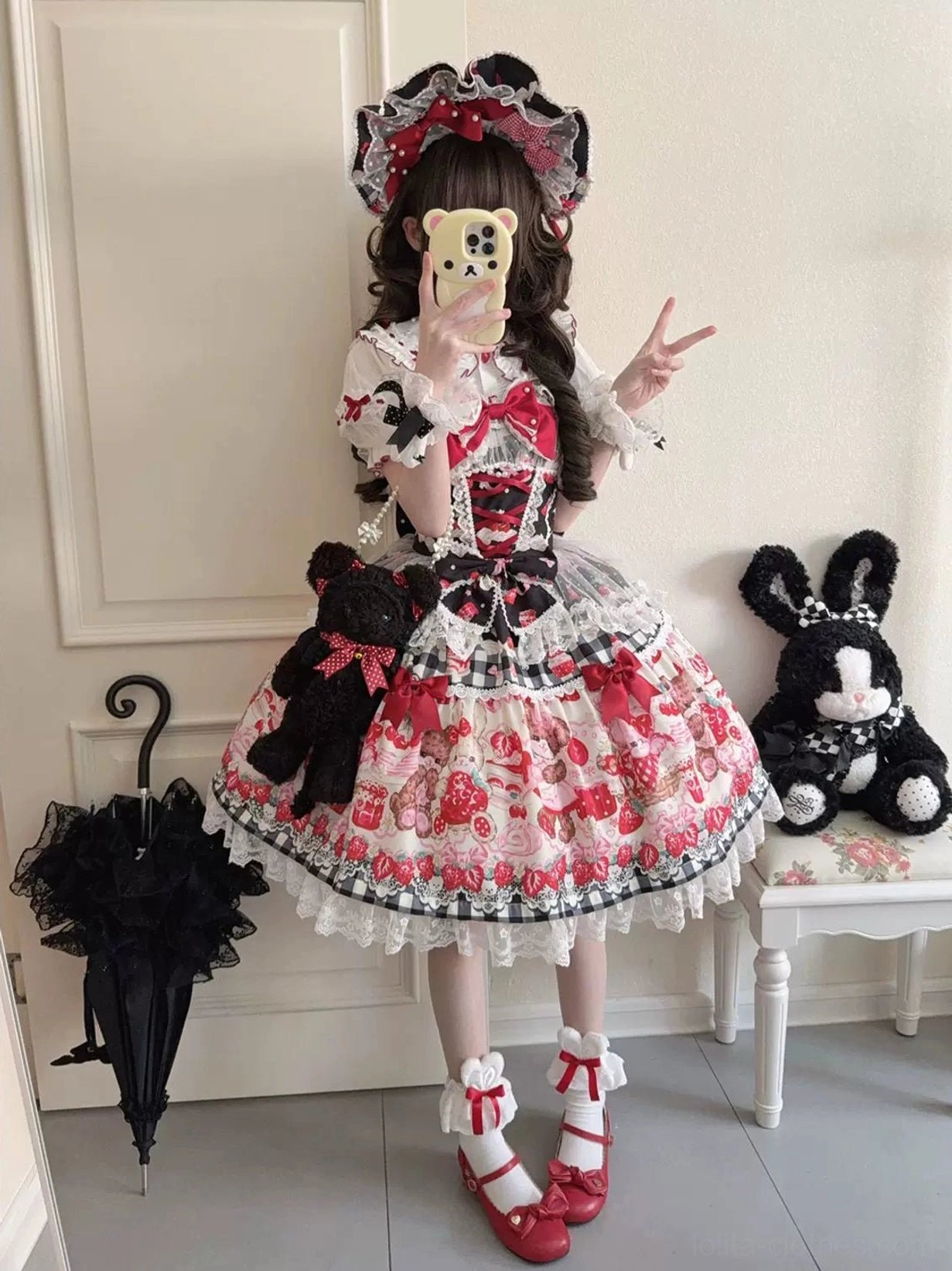 Sweet lolita jumper skirt front chest detail with pearl-adorned red bow and chain accent centerpiece