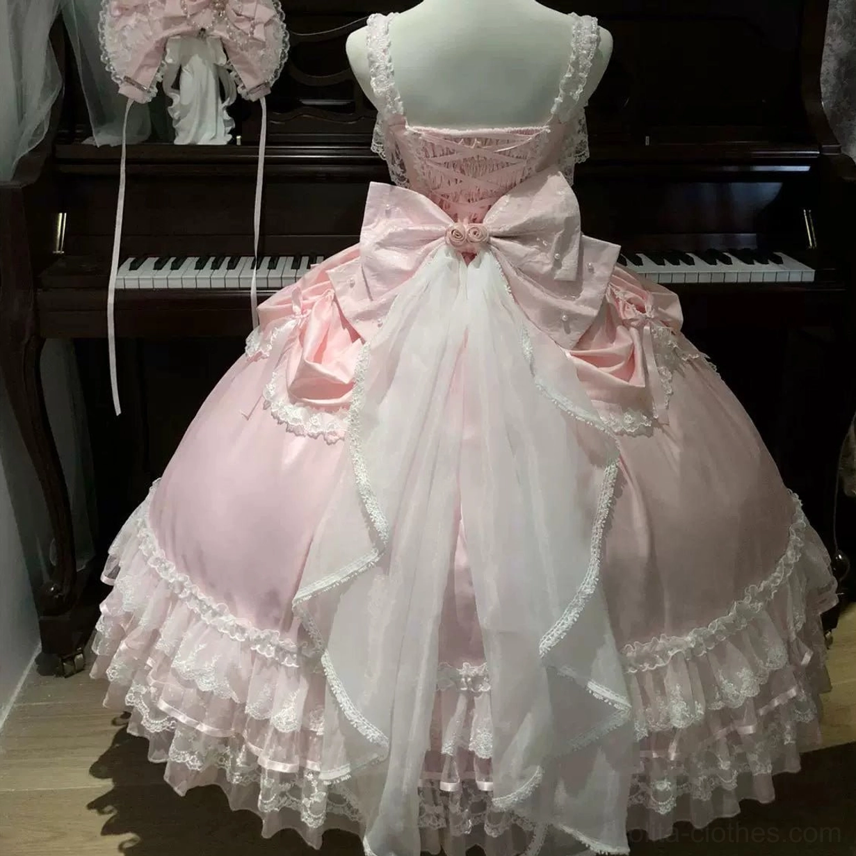Pink and white sweet wedding Lolita JSK dress color comparison showing petal-shaped bodice, bow accents, and tiered ruffle skirt silhouette in both romantic pink and pristine white options