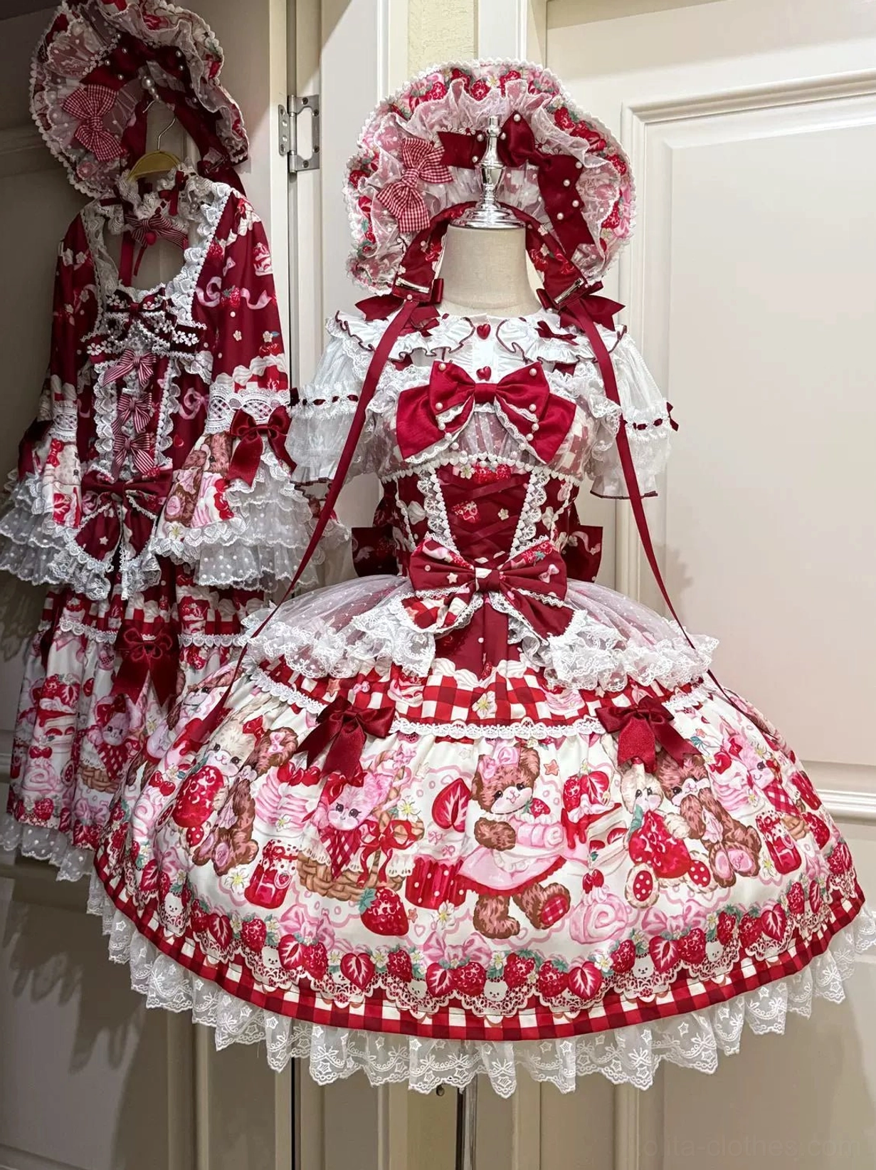 Red sweet lolita strawberry bear JSK dress detail shot showing pearl bow chain bodice accent and lace layers