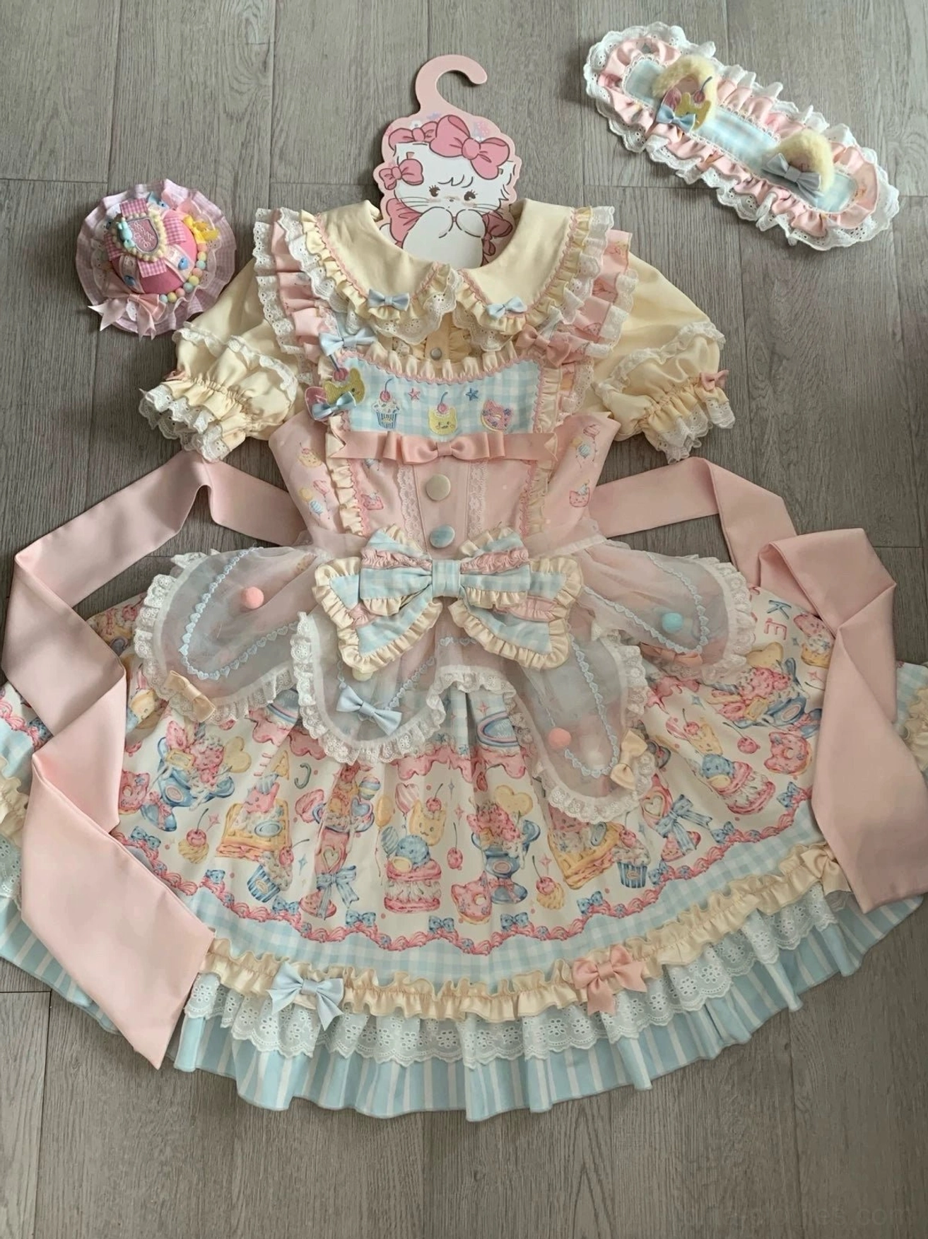 Sweet lolita jsk dress flat lay top-down pastel cat dessert print with lace ruffles bow and accessories