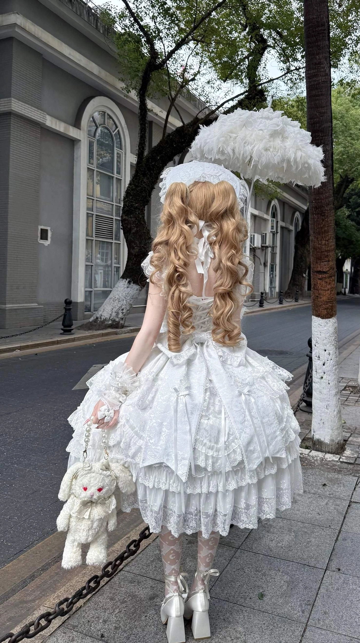 Lolita jumper skirt tiered construction showing lace flutter sleeves and shoulder strap design for gentle feminine silhouette