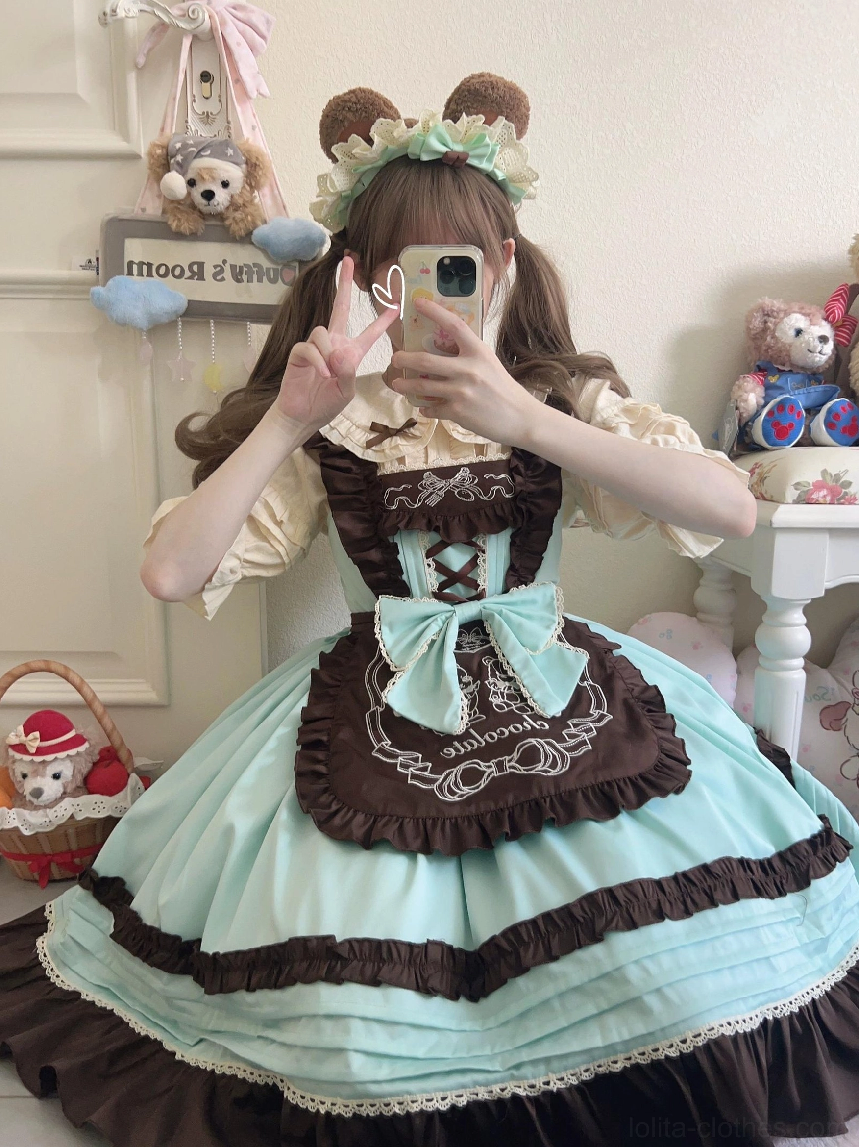 Mint green maid-style sweet lolita JSK dress with brown embroidered apron, large waist bow, tiered ruffled hem, worn with bear ear headband and cream blouse