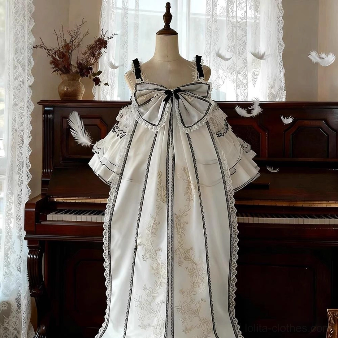 Sweet lolita JSK dress waist detail showing black satin ribbon, embroidered design elements and transition between bodice and layered tulle skirt
