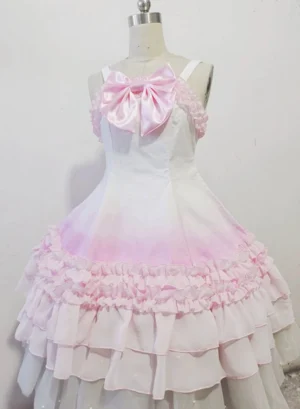 Sweet lolita jumper skirt front full view on mannequin displaying white to pink ombre bodice, pink ruffled trims, layered chiffon hem, and pink satin ribbon bow with delicate lace detailing