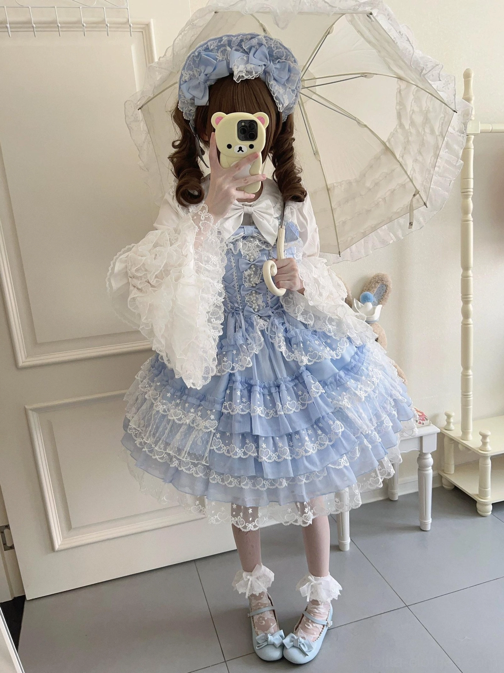 Sweet Lolita JSK dress front waist area showing bow placement, lace layering, and bodice construction details