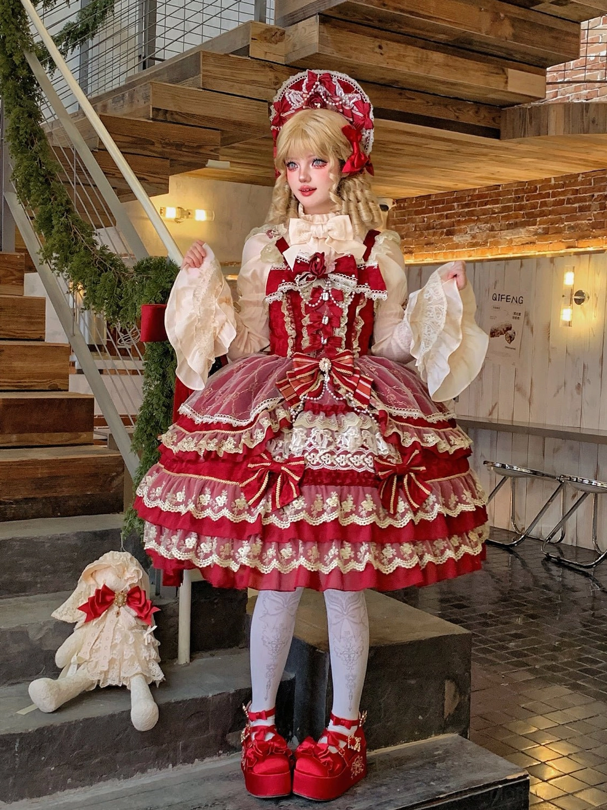 Sweet lolita JSK dress full front view showing multi-layered lace construction and satin bow decoration